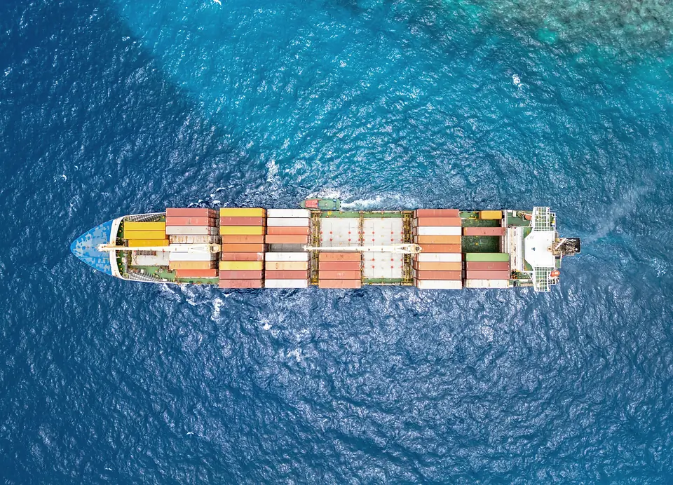Aerial view of a loaded container ship crossing open blue water